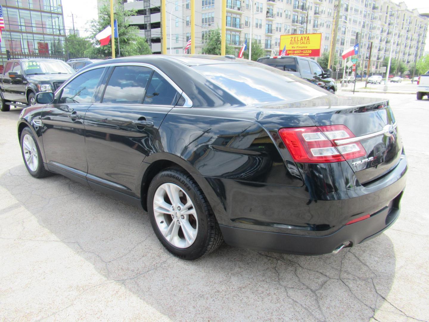 2014 Green /Tan Ford Taurus SEL FWD (1FAHP2E84EG) with an 3.5L V6 DOHC 24V engine, Automatic transmission, located at 1511 North Shepherd Dr., Houston, TX, 77008, (281) 657-1221, 29.798361, -95.412560 - 2014 Ford Taurus Sel 108,699 mi VIN: 1FAHP2E84EG109641 Original Window Sticker Vehicle Details Sedan 4 DR 3.5L V6 F DOHC 24V Gasoline Front wheel drive - Photo#9