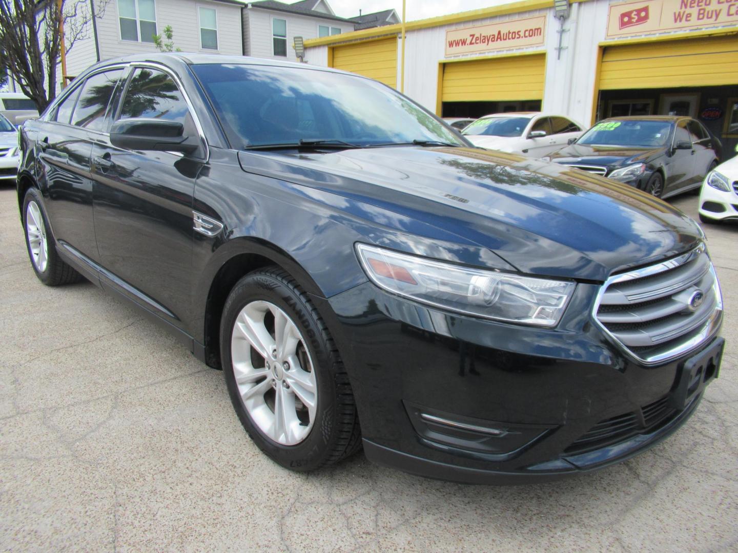 2014 Green /Tan Ford Taurus SEL FWD (1FAHP2E84EG) with an 3.5L V6 DOHC 24V engine, Automatic transmission, located at 1511 North Shepherd Dr., Houston, TX, 77008, (281) 657-1221, 29.798361, -95.412560 - 2014 Ford Taurus Sel 108,699 mi VIN: 1FAHP2E84EG109641 Original Window Sticker Vehicle Details Sedan 4 DR 3.5L V6 F DOHC 24V Gasoline Front wheel drive - Photo#13