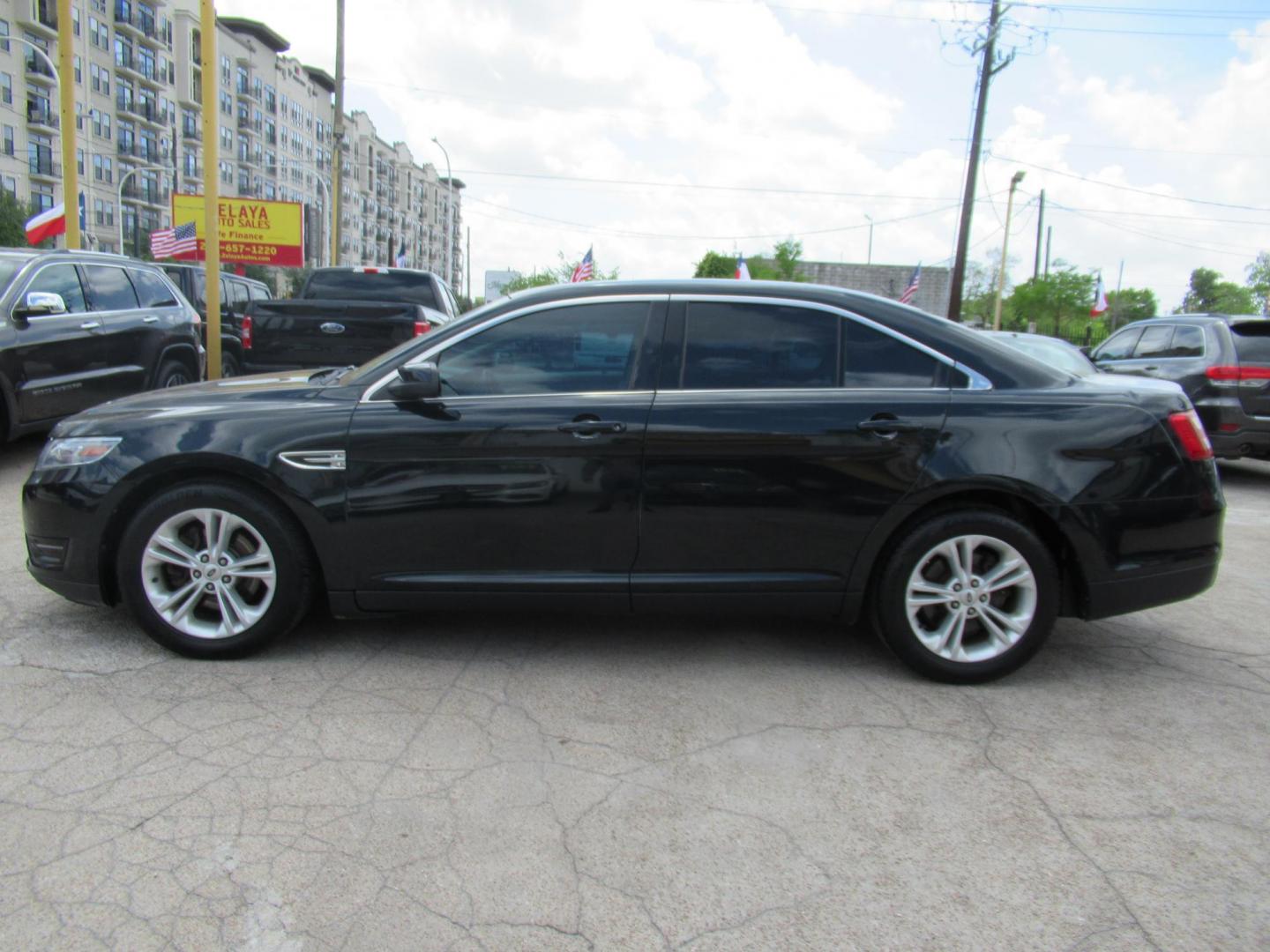 2014 Green /Tan Ford Taurus SEL FWD (1FAHP2E84EG) with an 3.5L V6 DOHC 24V engine, Automatic transmission, located at 1511 North Shepherd Dr., Houston, TX, 77008, (281) 657-1221, 29.798361, -95.412560 - 2014 Ford Taurus Sel 108,699 mi VIN: 1FAHP2E84EG109641 Original Window Sticker Vehicle Details Sedan 4 DR 3.5L V6 F DOHC 24V Gasoline Front wheel drive - Photo#16